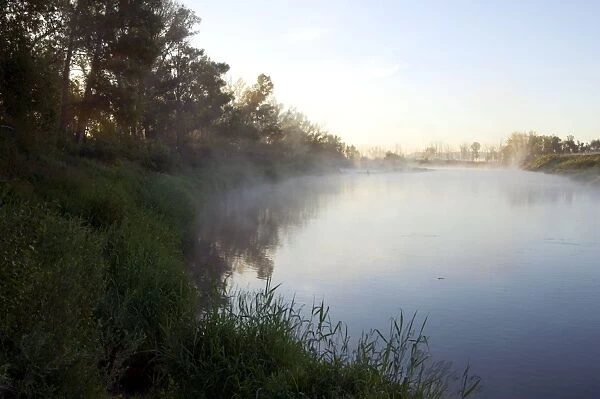 Russia - morning mist at a sunrise on a river Sakmara ( a tributary of river Ural) - a typical river scene South of Ural Mountains - Orenburg region - South Russia - June