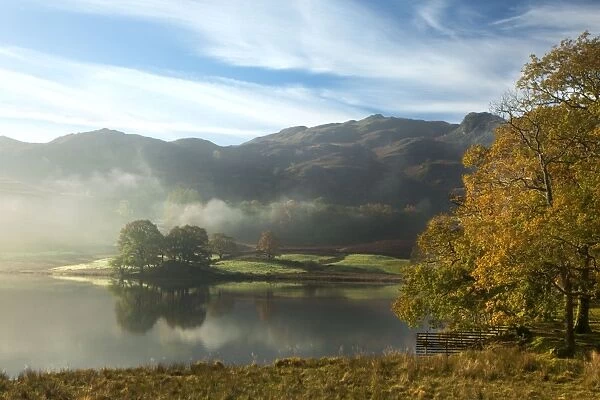 Rydal Water on a beautiful calm autumn's morning with a layer of mist - October - Lake District - England