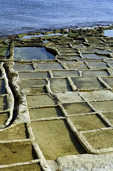 Salt pans at Marsaskala, Malta look like shallow trays cut into the stone. They were created by the Knights in the 17th century. There are a number of sites around the island's coast - most are disused