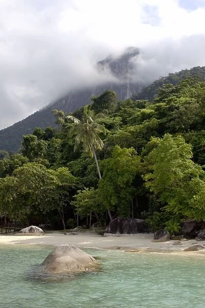 Sand beach and rainforest on slopes of volcanic Tioman Island, 30 km east off peninsula Malaysia in South China Sea; a scene near small 'Bagus Place Retreat' resort; June. Ma39. 3455