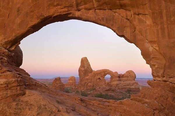 Sandstone arches - Turret Arch seen through the North Window at morning right before sunrise - Arches National Park, Utah, USA