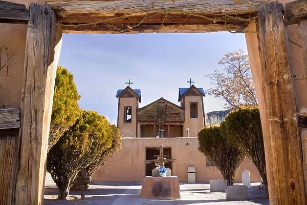 Santuario de Chimayo - entrance portal with view towards plaza and the santuario, a beautiful historic mission in adobe building style - Chimayo, High Road to Taos, New Mexico, USA