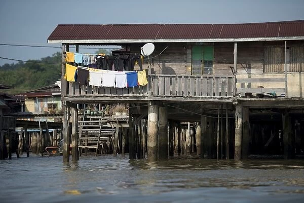 Shack on stilts with washing in river