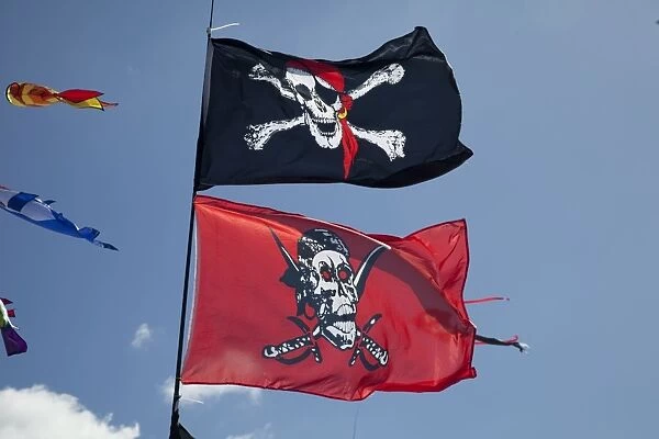 Skull and crossbones flags flying against blue sky - Greenbelt Festival 2010 - Cheltenham - UK