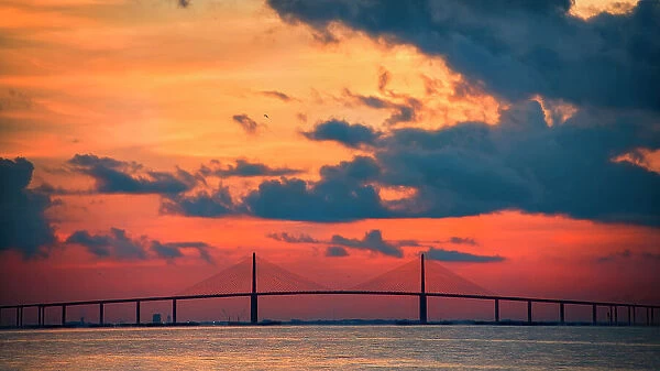 The Skyway Bridge over the Gulf of Mexico with the reds and oranges of the sunrise in the sky. Date: 26-07-2014