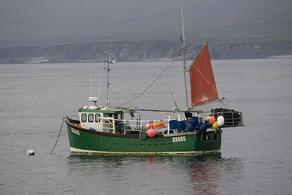Small fishing boat moored in Port Asaig Isle of Islay Scotland UK