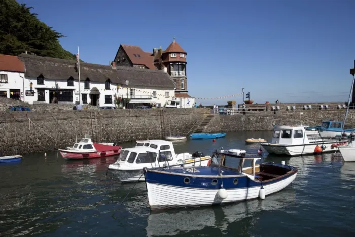 Framed Print : Small fishing boats in Lynmouth harbour with - Rhenish tower in background North Devon UK Framed Print : Small fishing boats in Lynmouth harbour with - Rhenish tower in background North Devon UK