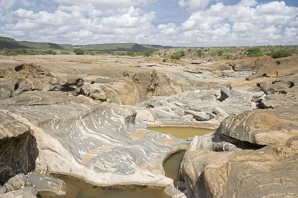 Smooth eroded rocks below Lugard Falls on Galana River Tsavo East National Park Kenya