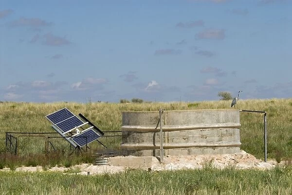 Solar panel for powering water pump at waterhole, replacing previous windmill. Kgalagadi Transfrontier Park, Northern Cape, South Africa