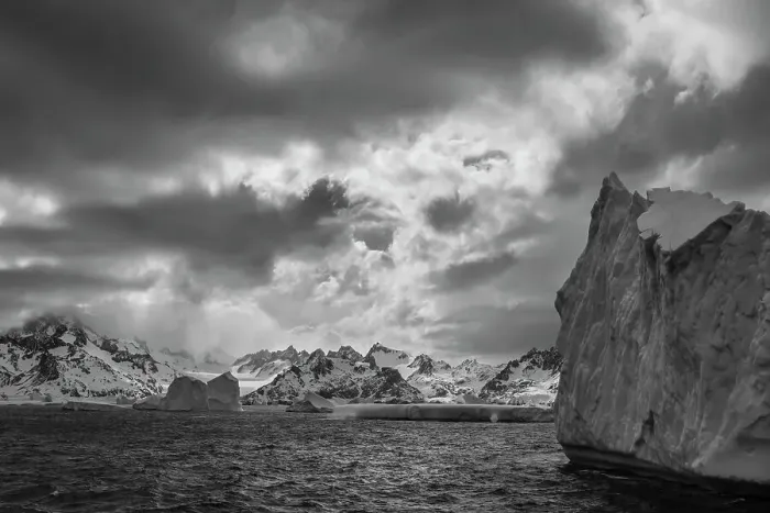 Framed Print : South Georgia Island. Black and white Landscape of iceberg floating in the Atlantic and mountain scenery. Date: 18-10-2019