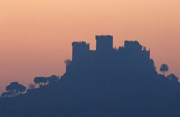 Spain - The impressive eighth-century castle of Almodovar del Rio perches high above the Guadalquivir river valley; at dawn. Province of Cordoba, Andalucia, Spain