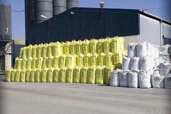 Stacks of fertiliser sacks on dockside St Malo Brittany, France