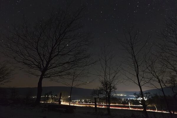 Starlit Sky - and car headlight trails - village in winter