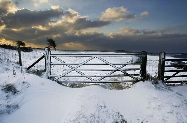 Sun bursting through clouds over a snowy landscape - South Downs - East Sussex - United Kingdom