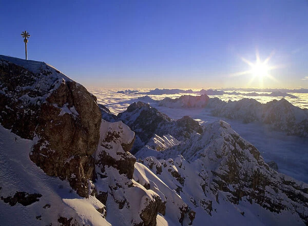 Sunrise on Zugspitze view from highest mountain of Germany with summit cross at sunrise Bavaria, Germany