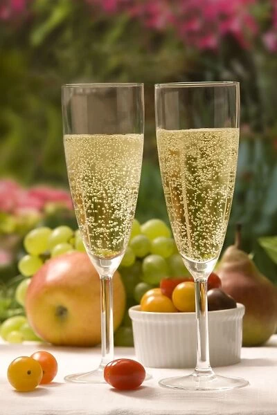 Table - with two glasses of sparkling wine and fruit