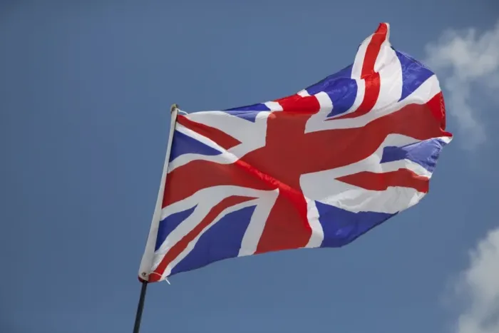 Framed Print : Union Jack flag - flying in light breeze against blue sky - UK Framed Print : Union Jack flag - flying in light breeze against blue sky - UK