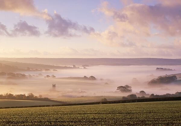 United Kingdom - misty valley with church & clouds. Harberton, Devon, UK