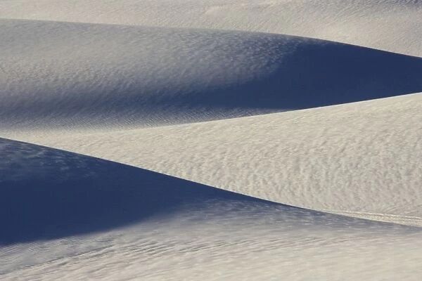 USA - The glistening dunes of White Sands in the Tularosa Basin are not sand, but fine gypsum, deposited on an ancient seabed 250 million years ago. Gypsum, a form of calcium sulfate, is water soluble and washes away