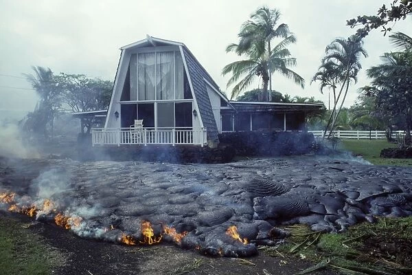 USA - Hawaii - Big Island - Eruption of the Pu'u O'o Vent - a vent of the Kilauea Volcano - Advancing lava flow surrounds a house in the village of Kalapana Gardens on the south shore of the island