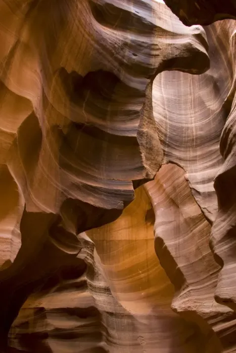 Framed Print : USA - Light that penetrates into the narrow canyon walls creates beautiful hues on the graceful curves of sandstone rock in the Upper Antelope Canyon, probably the most famous slot canyon in the Southwest. Antelope Canyon