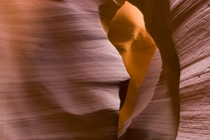 Framed Print : USA - Light that penetrates into the narrow canyon walls creates beautiful hues on the graceful curves of sandstone rock in the Lower Antelope Canyon, probably the most famous slot canyon in the Southwest. Antelope Canyon