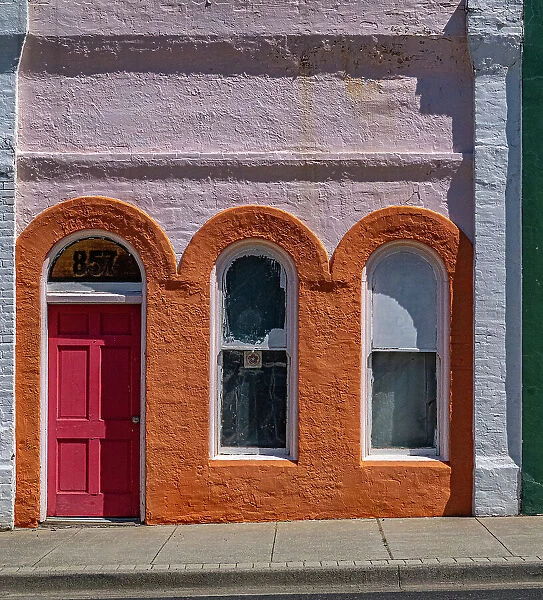 USA, Washington State, Pomeroy. Colorful old building with arched windows and doorway with scale Date: 04-06-2020