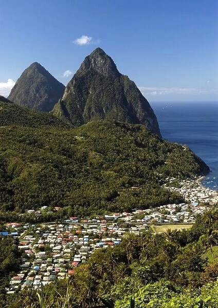A view of The Pitons Mountains, with dense green undergrowth in the middle ground. St Lucia