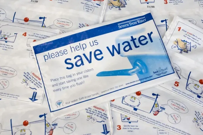 Framed Print : Water conservation - placing water hippo saveaflush bags, provided free by Severn Trent Water, in toilet cistern helps conserve water each time the toilet is flushed. UK Framed Print : Water conservation - placing water hippo saveaflush bags, provided free by Severn Trent Water, in toilet cistern helps conserve water each time the toilet is flushed. UK