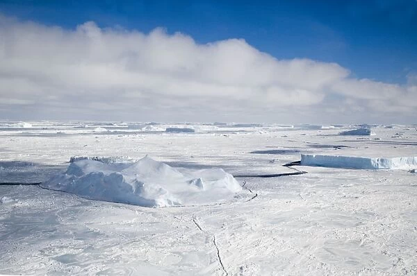 Weddell Sea with Icebergs frozen fom last summer and cracks appearing in October springtime, Antarctic