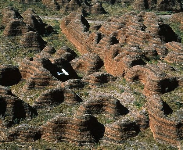 Western Australia Pumululu National Park Bungle Bungle Range. Sandstone range formed 400 million years ago from layered sediments washed into a rift valley. Eroded into beehive formations & deep canyon-type valleys