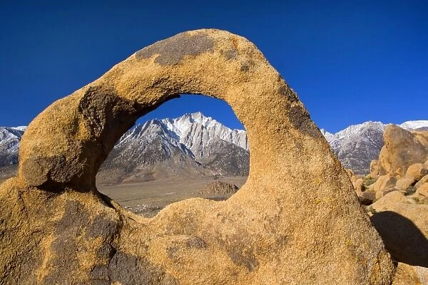 Whitney Portal Arch - Lone Pine, one of the snow-capped mountains of the Sierra Nevada, seen through Whitney Portal Arch - Alabama Hills Recreation Area, California, USA