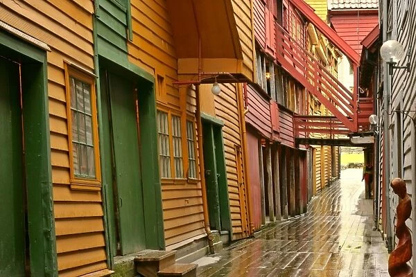 wooden houses alley and colourful historic trade houses in UNESCO world heritage site of Bryggen Bergen, Norway