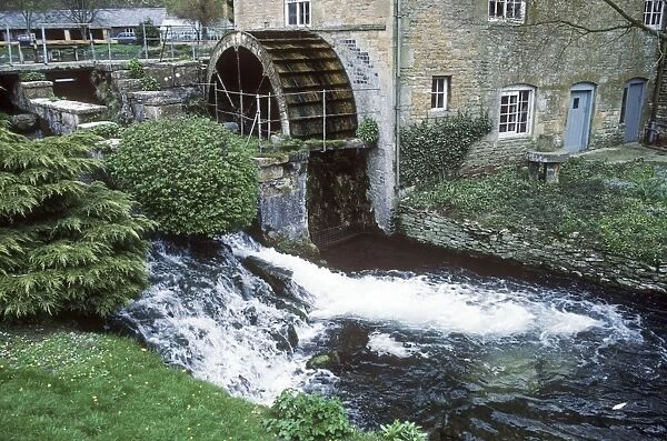Working water wheel providing power for Donnington Brewery Cotswolds UK