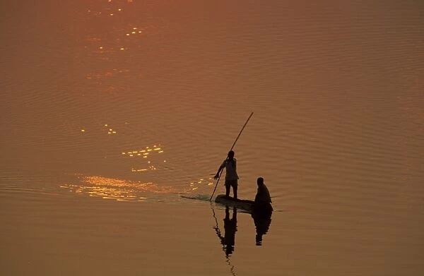 Zambia - Fishermen at sunset on the Luangwa river. South Luangwa National Park, Zambia