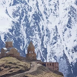 14th century Gergeti Trinity Church (Georgian Orthodox) high in the mountains above Stepantsminda, Kazbegi in the Great Caucasus, Georgia