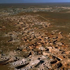 Aerial - Opal mining from the air, and town of Coober Pedy beyond - South Australia JPF51910