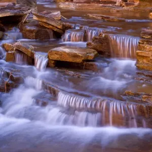 Cascades in Kalamina Gorge - picturesque cascades in Kalamina Gorge, surrounded by steep, terraced red walls. The cascade is in the shade but the reflecting walls cast a warm light upon the whole scenery - Kalamina Gorge, Hamersley Range Cascades in Kalamina Gorge - picturesque cascades in Kalamina Gorge, surrounded by steep, terraced red walls. The cascade is in the shade but the reflecting walls cast a warm light upon the whole scenery - Kalamina Gorge, Hamersley Range