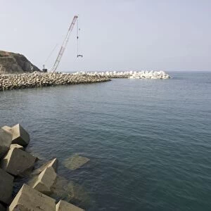 Constructing new breakwater outside harbour Puerto de Vega Costa Verde Northern Spain