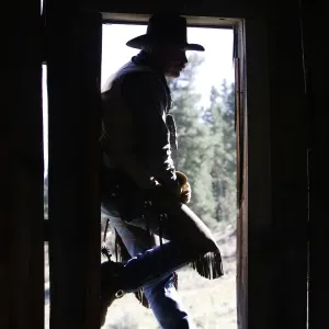 Cowboy - silhouetted in door frame. Ponderosa Ranch - Seneca - Oregon - USA Cowboy - silhouetted in door frame. Ponderosa Ranch - Seneca - Oregon - USA