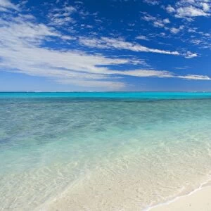 Dream Beach - white sandy beach, clear turquoise coloured water and a deep blue sky combine to a perfect beach. The shallow reef is recognizable as darker blue spots in the ocean