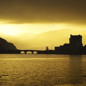 Eilean Donan Castle - being silhouetted in atmospheric conditions - November - Scotland Eilean Donan Castle - being silhouetted in atmospheric conditions - November - Scotland