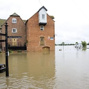 Flooding - Abbey Mill surrounded by flood River Avon opposite Tewkesbury Abbey Gloucestershire UK Level of Rivons Avon and Severn almost at 1947 levels