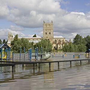 Flooding - childrens playground underwater with Tewkesbury Abbey in background. Unprecedented flooding of the Rivers Severn and Avon July 2007 Gloucestershire UK