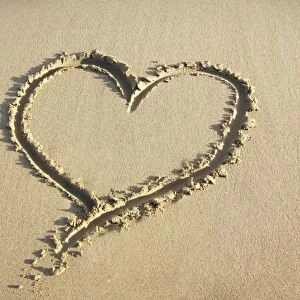 Heart drawn in the sand of a beach