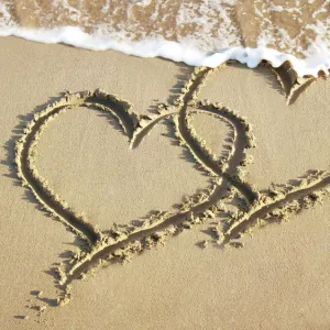 Heart drawn in the sand of a beach Digital Manipulation: added hearts together & sea