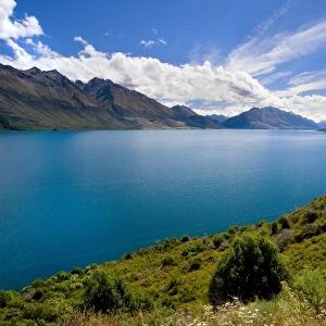 Lake Wakatipu surrounded by stunning mountains with dispersing clouds after a heavy thunderstorm Queenstown, Otago, South Island, New Zealand