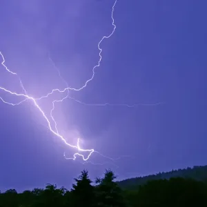 Lightning and thunder clouds-over woodland at night, Bramwald, Lower Saxony, Germany Lightning and thunder clouds-over woodland at night, Bramwald, Lower Saxony, Germany