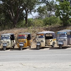 Line of Tuk-Tuk three wheeled motorised rickshaw taxis waiting for passengers Kilifi - Kenya