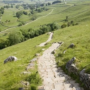 Malham Cove is a famous outcrop of curved limestone cliffs in Yorkshire Dales, UK. Over 250 ft high this was once the location of a spectacular waterfall though today there is only a small beck or tarn flowing from the base